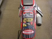 Another dirt bike tail wrapped with General Formulations Motomark with various sponsor logos on it